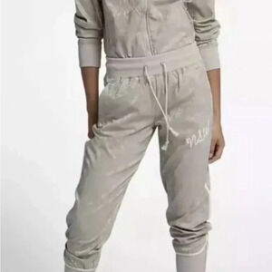 Nike Women’s Sportswear Track LS Jacket and Jogger NSW ChampagneEmbroidered Logo